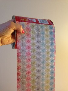 Line up the scrapbook paper of your choice.  I lined mine up with the bottom so that it didn't interfere with the lid.