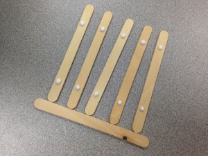 Line up five Popsicle sticks. I used an extra stick at the bottom to make sure they were lined up good.