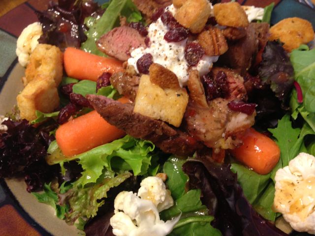 Bed of spring mix, steak, carrots, cauliflower, low fat cottage cheese, pecans, cranberries, light italian dressing, and a sprinkle of croutons for a crunch!