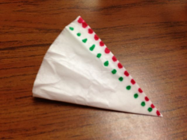 Start making a design on the filter with markers. Since the filter is wet, watch the color spread throughout!