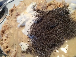 After shredding the chicken, mix the sour cream, cream of chicken, poppy seeds, and shredded chicken.