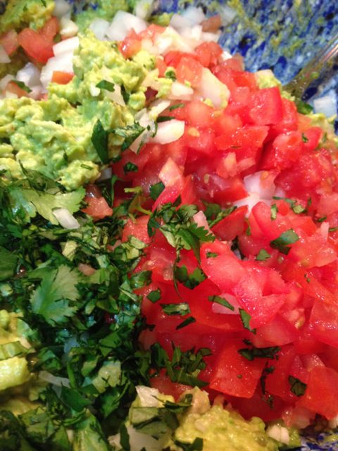 Add the fresh chopped onion, garlic, tomatoes, and cilantro by folding it in.