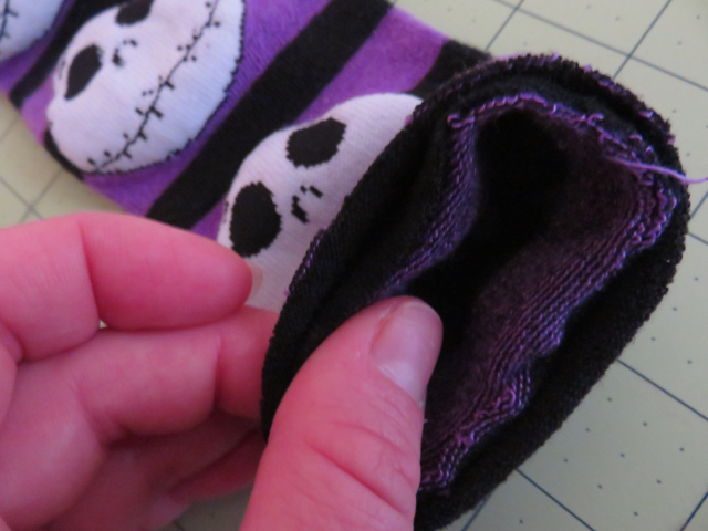 With the sock right side out, place your cuff with the selvage edges together.