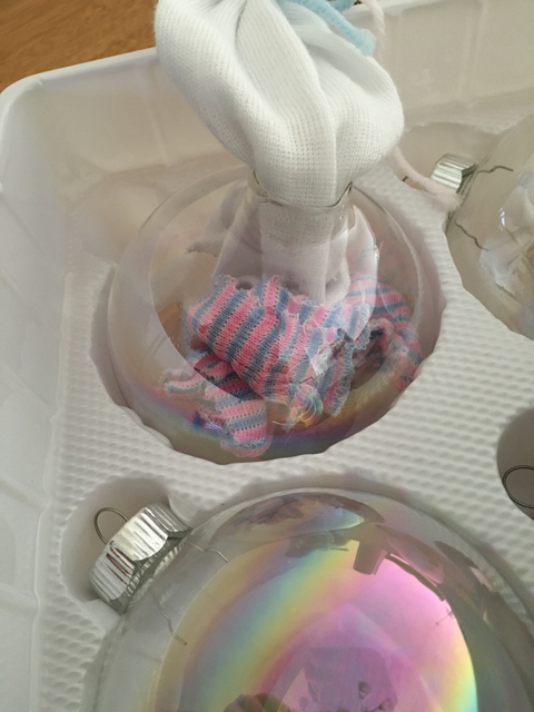 I pulled the top off and set the bulb down in the tray to hold it there. Avery's hat actually consisted of a hospital hat with another hospital hat as the bow, so I had to really work it in there! After I finally squeezed it in, I added her hospital bracelet.